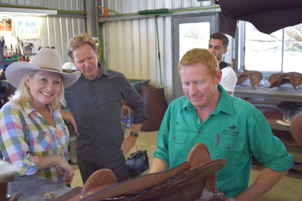 The Totally Wild crew Stacey, Glen and Peter being shown the saddle making process by saddle maker, Ben Kent. 